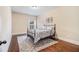 Bedroom featuring hardwood floors and an iron bed frame at 2620 Paddock Point Pl, Dacula, GA 30019