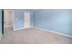 Spacious bedroom featuring neutral carpet, walls, and bright blue accent wall at 2620 Paddock Point Pl, Dacula, GA 30019