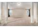 Large bonus room featuring multiple windows, neutral colors, and plush carpeting at 2620 Paddock Point Pl, Dacula, GA 30019