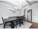 Formal dining room featuring a table and seating for six under a coffered ceiling at 2620 Paddock Point Pl, Dacula, GA 30019