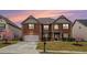 Charming two-story brick home with a well-manicured lawn and attached two-car garage at 2620 Paddock Point Pl, Dacula, GA 30019