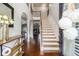 Grand foyer with high ceilings, hardwood floors, and an elegant staircase with iron spindles at 2620 Paddock Point Pl, Dacula, GA 30019