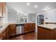 Open kitchen with hardwood floors, granite countertops, and an island at 2620 Paddock Point Pl, Dacula, GA 30019