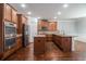 Gourmet kitchen with stainless appliances, granite countertops, a center island, and hardwood flooring at 2620 Paddock Point Pl, Dacula, GA 30019