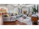 Spacious living room features a coffered ceiling, fireplace, and plush sectional sofa at 2620 Paddock Point Pl, Dacula, GA 30019