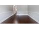 Room with hardwood floors, white trim, light grey walls and archway at 2620 Paddock Point Pl, Dacula, GA 30019