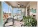Comfortable screened-in porch with ceiling fan and decorative curtains at 2620 Paddock Point Pl, Dacula, GA 30019