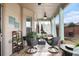 Cozy screened in porch with two chairs, loveseat and ceiling fan at 2620 Paddock Point Pl, Dacula, GA 30019
