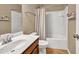 Bathroom with wood vanity, white sink and a shower with white tile and shower curtain at 4125 Madison Bridge Dr, Suwanee, GA 30024