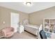 Bedroom with tan walls, string lights, single bed, chair, bookshelf, and a window at 4125 Madison Bridge Dr, Suwanee, GA 30024