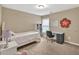Cozy bedroom with neutral walls, a twin bed, black desk and a window for natural light at 4125 Madison Bridge Dr, Suwanee, GA 30024