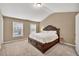 Primary bedroom featuring neutral walls, carpet, and a large window providing natural light at 4125 Madison Bridge Dr, Suwanee, GA 30024