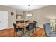 Traditional dining room featuring hardwood floors, neutral walls, and a wooden table with seating for six at 4125 Madison Bridge Dr, Suwanee, GA 30024