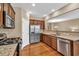 Well-equipped kitchen with stainless steel appliances, granite counters, and modern cabinetry at 4125 Madison Bridge Dr, Suwanee, GA 30024