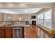 Open-concept living space showcasing a modern kitchen with a view into the living room with fireplace at 4125 Madison Bridge Dr, Suwanee, GA 30024