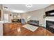 Spacious open-concept living area featuring a fireplace, hardwood flooring, and ample seating at 4125 Madison Bridge Dr, Suwanee, GA 30024