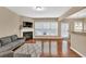 Bright living room with hardwood floors, a fireplace, and large windows offering ample natural light at 4125 Madison Bridge Dr, Suwanee, GA 30024