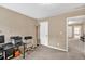 Office with beige carpet, tan walls, a black desk, printers, white storage, and a window at 4125 Madison Bridge Dr, Suwanee, GA 30024
