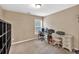 Functional office space with a window, neutral walls, desk, chair and storage at 4125 Madison Bridge Dr, Suwanee, GA 30024