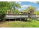 A large deck with a wooden rail sits in the green backyard of the property at 454 Jo Ann Se Dr, Marietta, GA 30067