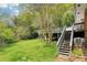 Backyard with grassy area and staircase that leads up to the deck with railing at 454 Jo Ann Se Dr, Marietta, GA 30067