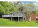 Backyard view showcasing an elevated deck supported by wooden pillars amid lush green landscape at 454 Jo Ann Se Dr, Marietta, GA 30067