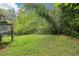 The backyard with the patio is surrounded by lush bamboo and trees, creating a private outdoor haven at 454 Jo Ann Se Dr, Marietta, GA 30067