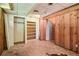 Unfinished basement featuring wood paneled walls and vinyl flooring at 454 Jo Ann Se Dr, Marietta, GA 30067