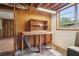 Basement with work table and wood paneled walls next to a window providing natural light at 454 Jo Ann Se Dr, Marietta, GA 30067