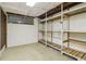 Unfinished basement room featuring a window and built in shelving at 454 Jo Ann Se Dr, Marietta, GA 30067