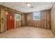 Spacious unfinished basement with paneled walls, tiled floor, and exterior door at 454 Jo Ann Se Dr, Marietta, GA 30067