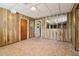 Spacious unfinished basement with paneled walls, tiled floor, and fire extinguisher at 454 Jo Ann Se Dr, Marietta, GA 30067