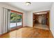 Dining room with hardwood floors, access to a wooden deck, and view into the kitchen at 454 Jo Ann Se Dr, Marietta, GA 30067