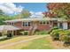 Charming brick home with a covered carport and well-maintained lawn, exuding classic curb appeal at 454 Jo Ann Se Dr, Marietta, GA 30067