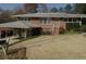 Charming brick home featuring a covered parking area, classic design elements, and a well-maintained lawn at 454 Jo Ann Se Dr, Marietta, GA 30067