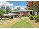 Charming brick home with a covered parking area and lush green lawn, creating a welcoming curb appeal at 454 Jo Ann Se Dr, Marietta, GA 30067