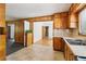 Spacious kitchen view with wooden cabinets, laminate countertops, and an access to a room with hardwood floors at 454 Jo Ann Se Dr, Marietta, GA 30067