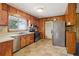 Kitchen featuring wooden cabinets, laminate countertops, and stainless-steel appliances at 454 Jo Ann Se Dr, Marietta, GA 30067