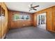 Living room with wood paneled walls, carpeted floors, ceiling fan, and natural light at 454 Jo Ann Se Dr, Marietta, GA 30067