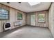 A sunroom featuring neutral walls, and natural light streaming through the windows and skylight at 454 Jo Ann Se Dr, Marietta, GA 30067