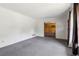Spacious living room with gray carpet and access to a wood-paneled room through an open doorway at 454 Jo Ann Se Dr, Marietta, GA 30067