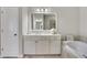 Bathroom with a double sink vanity, ample storage, and soaking tub at 552 Micayne Se Cir # 1, Smyrna, GA 30082