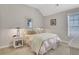Bedroom with neutral colors, a side table, and a window at 552 Micayne Se Cir # 1, Smyrna, GA 30082
