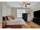 Cozy bedroom with ceiling fan, window, and carpet; featuring modern minimalist furnishings and decor at 552 Micayne Se Cir # 1, Smyrna, GA 30082