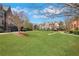 Serene community with lush green lawn, mature trees, and charming red footbridge, perfect for outdoor enjoyment at 552 Micayne Se Cir # 1, Smyrna, GA 30082