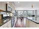 Kitchen and dining area featuring granite countertops, stainless steel appliances, and hardwood floors at 552 Micayne Se Cir # 1, Smyrna, GA 30082