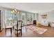 Bright living room featuring hardwood floors, a glass dining table, and a comfortable sitting area at 552 Micayne Se Cir # 1, Smyrna, GA 30082
