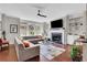 Cozy living room with a fireplace, built-in shelves, a large sectional sofa, and hardwood floors at 552 Micayne Se Cir # 1, Smyrna, GA 30082