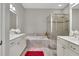 Bright main bathroom featuring double sink vanity, a tub and glass shower at 552 Micayne Se Cir # 1, Smyrna, GA 30082