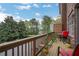 Charming outdoor patio with wooden railings, lush greenery, and a peaceful view of the neighborhood at 552 Micayne Se Cir # 1, Smyrna, GA 30082
